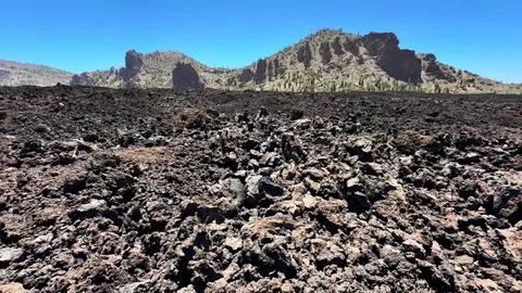 The breathtaking volcanic landscape features a rugged rocky terrain beneath Stock Photos