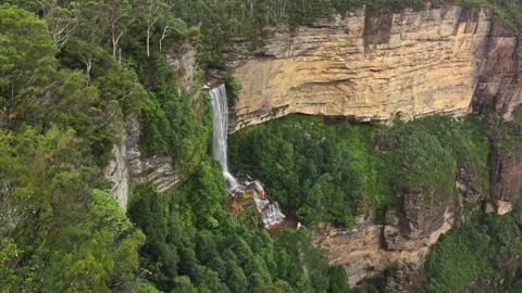 A breathtaking waterfall cascades down a cliff in Blue Mountains Katoomba Stock Footage 306123522