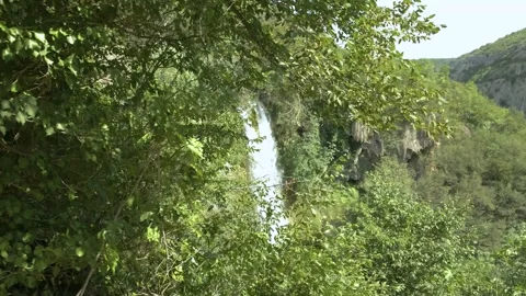 A breathtaking waterfall cascades down a mountain in a lush rainforest. Stock Footage 259075879
