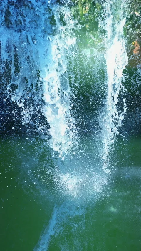 A breathtaking waterfall is cascading down elegantly into a vibrant and 스톡 동영상 287508840