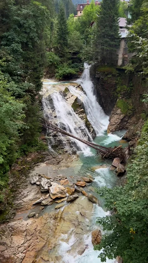 A breathtaking waterfall is elegantly surrounded by a lush green forest Stock Footage 292804889