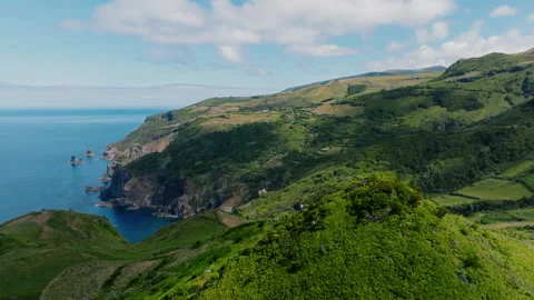 Breathtaking wide aerial drone view of rolling green hills and lush volcanic Видео 335710656