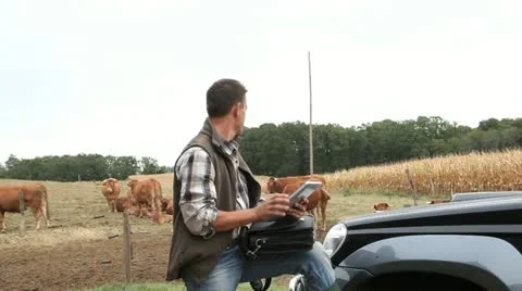 Breeder in farm using digital tablet Stock Footage 14833818