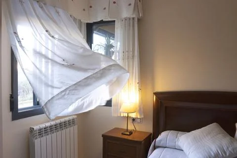 Breeze Blowing Through Open Window in Cozy Bedroom Stock Photos