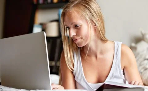 Breezing through her assignment. Young college student working on an assignment Foto stock
