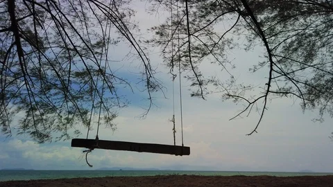 Breezy windy day blow an empty swing slowly. Stock Footage 105734651