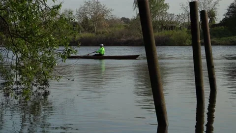 Bremen - 1 rower in rowboat rowing along Weser river close to Weserstadion Stock Footage 195987649