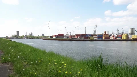 Bremen, 4k pan of container terminal of Industrial Harbor with Wind turbine Stock Footage 194668375
