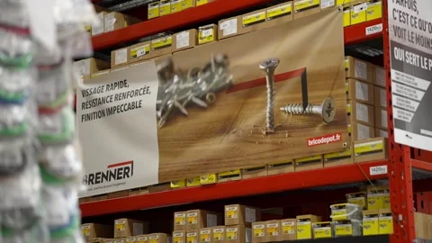 Brenner Fasteners on Red Shelving in Hardware Store Aisle with Promotional Video stock 332893515