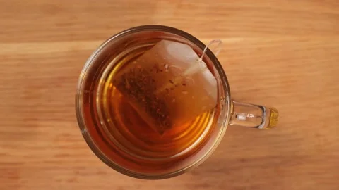 Brew a cup of hot tea - top down view 스톡 동영상 151059040