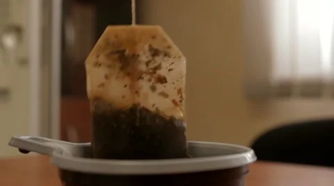 Brew tea bags in a plastic cup in the office Stock Footage 10876933
