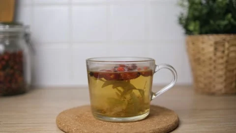 Brew tea from rosehip and lime blossom. Fruit tea. Brew in a cup. In the backgro Stock Footage 146694225