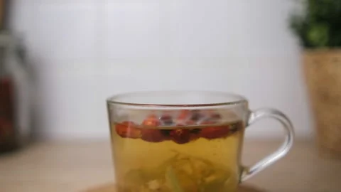 Brew tea from rosehip and lime blossom. Fruit tea. Brew in a cup. In the backgro Stock Footage 146694307