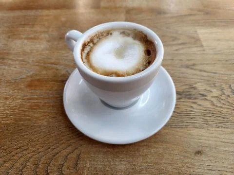 Brewed coffee in a white cup. White cup with coffee on a wooden table Stock Photos