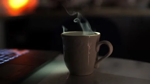 A brewed drink with boiling water in a ceramic cup against blurred backdrop Stock Footage 167706033