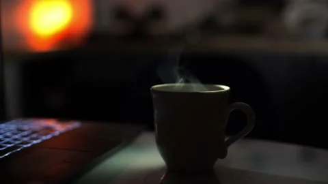 A brewed drink with boiling water in a ceramic cup against blurred backdrop Stock Footage 170478125