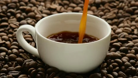 Brewed espresso coffee is poured into a white coffee cup Stock Footage 271125674