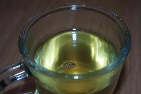 Brewed fragrant green tea or qehwa or qahwa on the wooden floor. Stock Photos