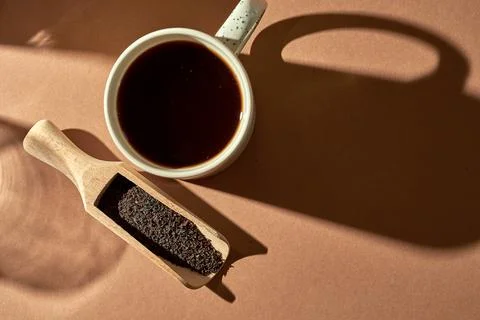 Brewed tea in a cup on a brown background. Turkish tea in a wooden spoon Stock Photos