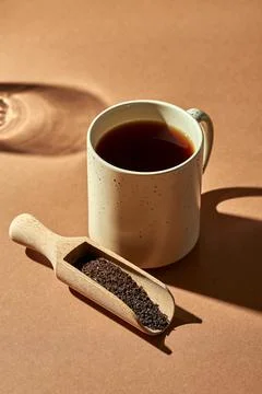 Brewed tea in a cup on a brown background. Turkish tea in a wooden spoon Stock-Fotos