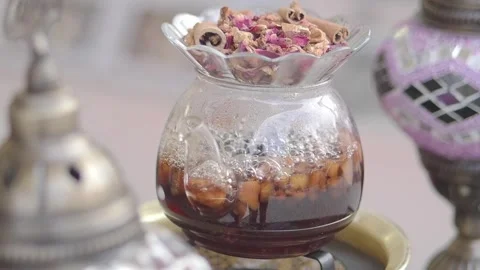 Brewed tea with herbs in a glass pot on a table Stock Footage 334273305