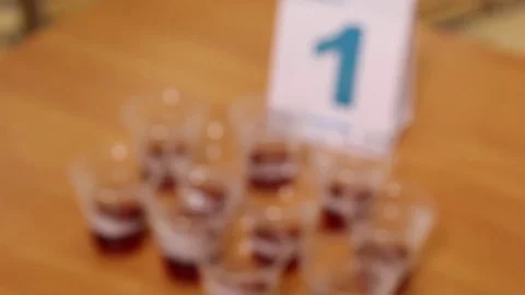 Brewed tea is poured over small glasses for tasting, black tea Stock Footage 75475130