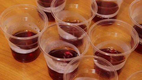 Brewed tea is poured over small glasses for tasting Stock Footage 75475232