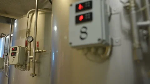 The brewer on the background of beer tanks makes calculations Stock Footage 99975144