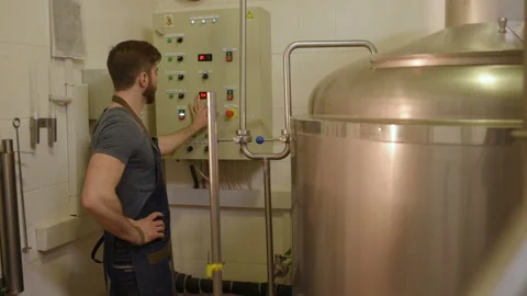 The brewer on the background of beer tanks makes calculations Stock Footage 100522147