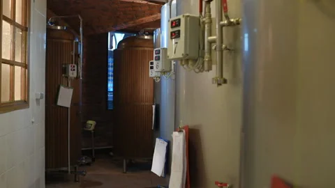 The brewer on the background of beer tanks makes calculations Stock-Footage 100525888
