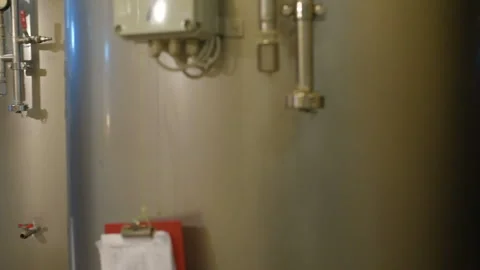 The brewer on the background of beer tanks makes calculations Stock-Footage 101426924