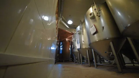 The brewer on the background of beer tanks makes calculations Stock-Footage 101427985