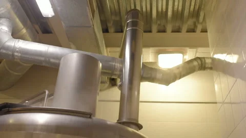 The brewer on the background of beer tanks makes calculations Video stock 102799453