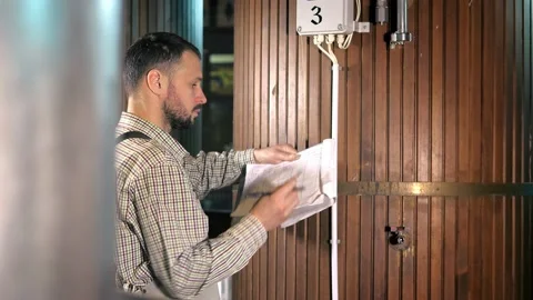 The brewer checks the indicators in the new generation of wooden barrels. Stock Footage 152921250