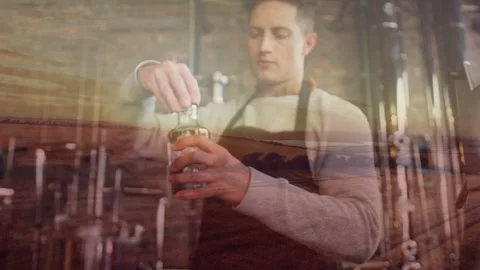Brewer coming into focus, reaching and twisting cap off jar in brewery, field Stock Footage 333936556