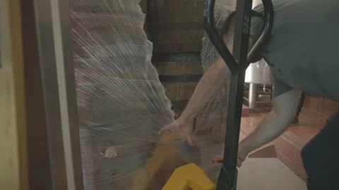 Brewer Cuts open Pallet Filled with Barrels Stock Footage 203508198