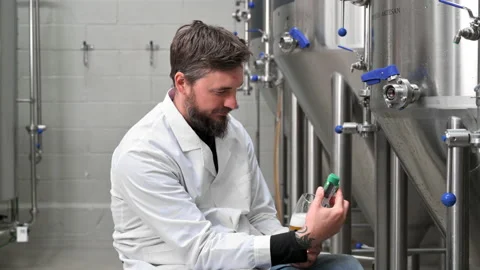 Brewer measuring pH in beer with digital meter. Stock Footage 194006962