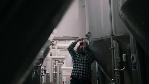 Brewer Pouring Fresh Craft Beer From The Fermentation Tank Video stock 131237110