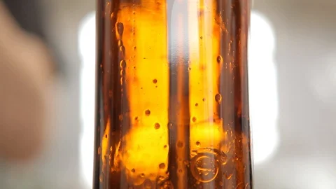 At the brewery, the bottle is filled with beer. Close-up. Stock Footage 113523673