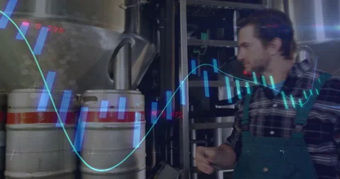 Brewery tech studying tank data activating chart overlays adjusting valve gauge Stock Footage 310658311