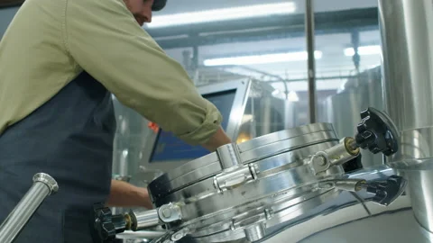 Brewery Worker Checking Beer Wort in Large Whirlpool Tank Video stock 236687377