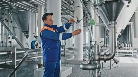 Brewery worker taking beer sample for quality control Stock Footage 337004254