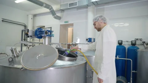 Brewery Worker Washes Production Container Tank Equipment Using Water Hose Stock Footage 220043245
