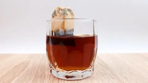 Brewing bagged black tea. Black tea in a bag, tea drinking. Stock Footage 278824214