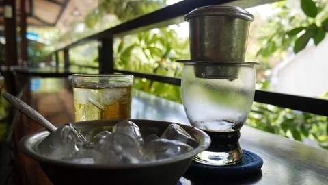 Brewing black coffee using a Vietnamese Traditional phin Filter in cafe. Coffee Stock Footage 113678566