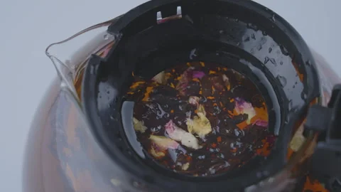 Brewing black tea with loose tea leaves and hot water 스톡 동영상 251234734