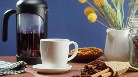 Brewing black tea in a teapot close-up. Drinking hot herbal drink on blue Stock Footage 169117496