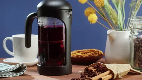 Brewing black tea in a teapot close-up. Drinking hot herbal drink on blue Видео 169373071
