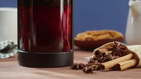 Brewing black tea in a teapot close-up. Drinking hot herbal drink on blue Stock Footage 169373102