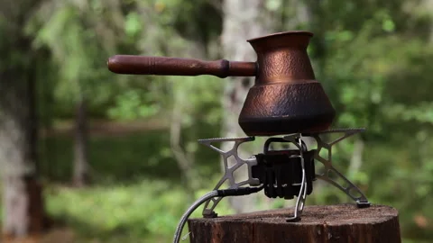 Brewing coffee on camping stove Stock Footage 247369544